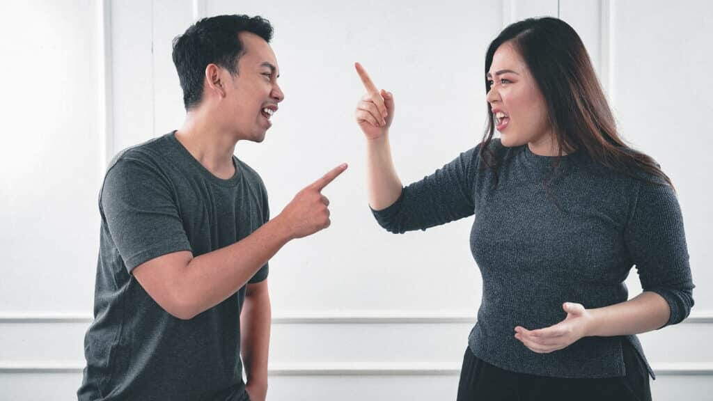 a man and woman arguing while pointing fingers stockpack pexels scaled