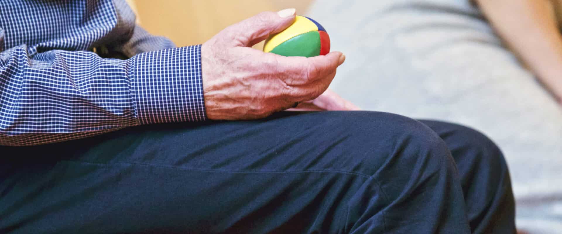 Person holding multicolored ball