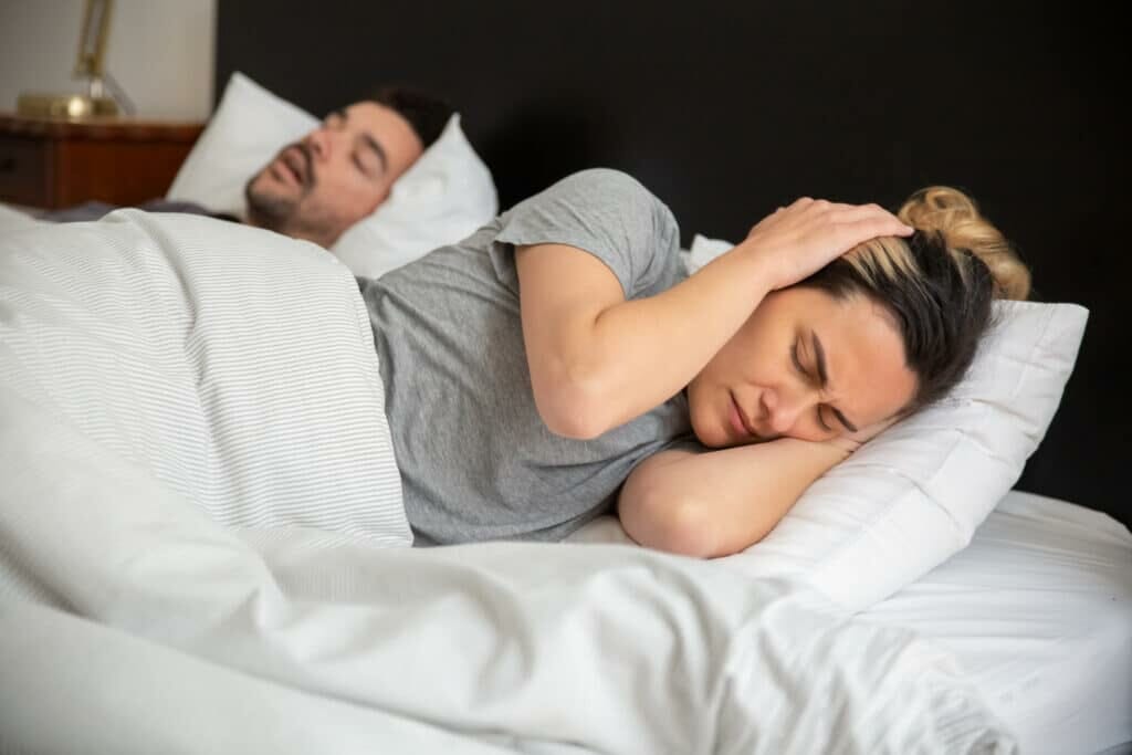 woman in gray shirt lying on bed stockpack pexels scaled